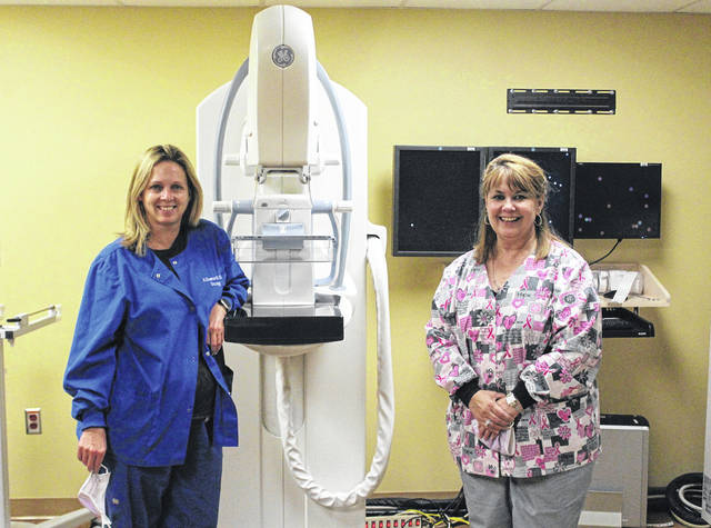 Heather Kremer (left), oncology nurse and member of BCADC, and Jill Brown (right), cancer coordinator at Wayne HealthCare and BCADC 5K Coordinator, pose next to some of Wayne’s state of the art cancer treatment and detection technology.
