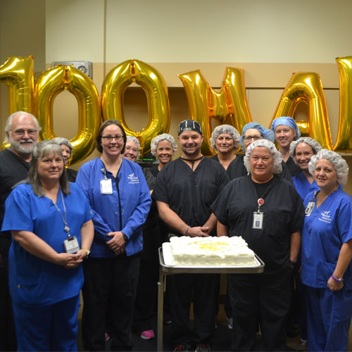 doctors with balloons and a cake