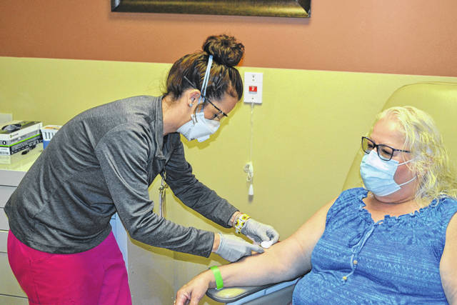 nurse offering antibody test to patient 